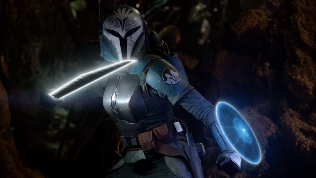 Η Bo-Katan Kryze κρατά το Darksaber και ενεργοποιεί ενεργειακή ασπίδα σε σκηνή δράσης από το Star Wars.