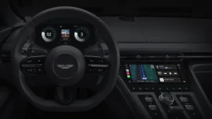 Interior view of Aston Martin with Apple CarPlay Ultra interface on dashboard and instrument cluster