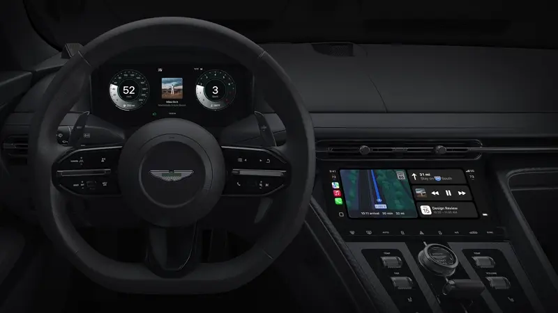 Interior view of Aston Martin with Apple CarPlay Ultra interface on dashboard and instrument cluster